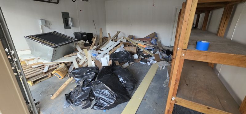 Garage filled with construction debris before cleanout